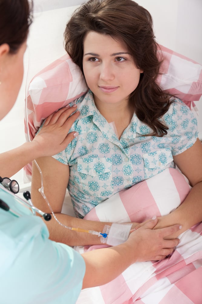 Young pretty sick woman in hospital and her sympathetic nurse Young pretty sick woman in hospital and her sympathetic nurse